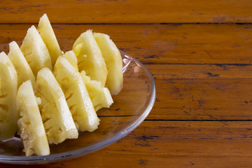 pineapple in plate on wood table