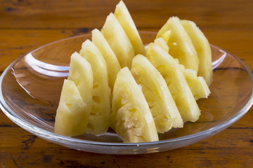 pineapple in plate on wood table