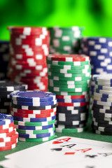 Playing cards and poker chips on green table