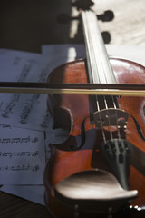 Traditional brown violin with bow on table