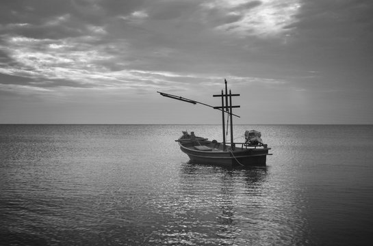 traditional fishing boat laying on the sea.cloudy sky.filtered image.selective focus.black and white color picture.HDR process