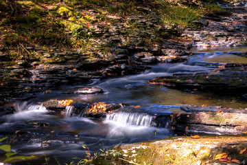 Serene waterfall flows gently at Raymondskill Falls near Milford, PA, in Autumn