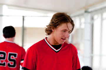 High school baseball player in dugout