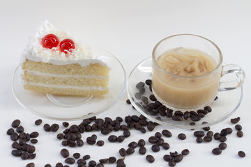white cake and coffe beans on white table