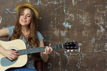Young woman with acoustic guitar.