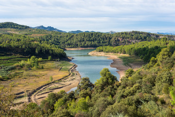Fototapeta na wymiar Water reservoir close to the village Capçanes in the the cormaca Priorat, province of Tarragona. The reservoir, named Pantà dels Guiamets, signifies Swamp, is an important water supply in the region