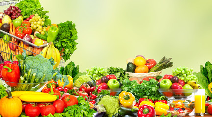 Naklejka na ściany i meble Vegetables and fruits over green background.