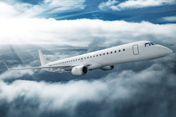 White airplane flying higher clouds at daytime