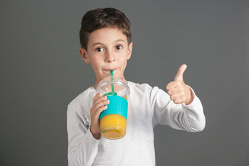 Little funny boy drinking a fresh juice through a straw © kleberpicui