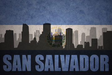 abstract silhouette of the city with text San Salvador at the vintage salvadoran flag
