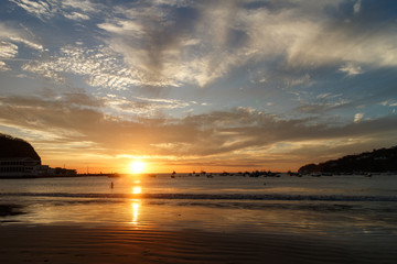 Sunset on a sea beach with fantastic sky clouds. Twilight reflection . San Juan del sur, Nicaragua