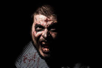 Vampire halloween man. Portrait of blood thirsty vampire man with blood dripping fangs - closeup.