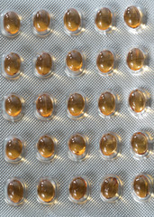 Closeup of Set Vitamin D pills with  fish oil