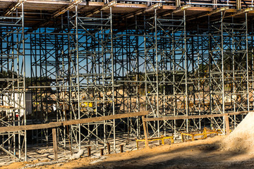 .construction scaffolding built under an overpass over the highw