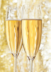 Two glasses of champagne on bokeh background