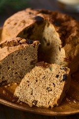 Traditional Chilean Pan de Pascua Christmas Cake made with spices, dried fruits and raisins, photographed with natural light (Selective Focus, Focus diagonally through the slice in the front)