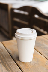 Take away coffee cup on a wooden table
