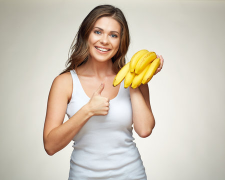 Toothy smiling woman hold bananas show thumb