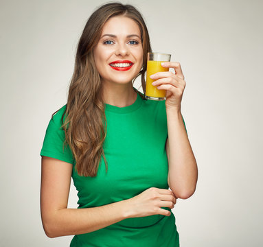 Young woman holding glass with orange juice.