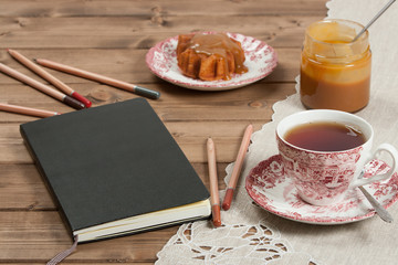 Closed Notepad. Homebaked Cake, Maple Leaf Shape. Cup Of Tea. To