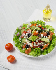 Fresh vegetable Greek salad with oil bottle
