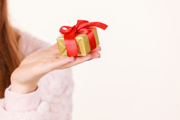 Female hand with golden box gift