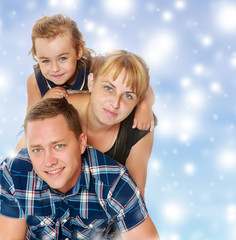 Fototapeta premium Mother and daughter sitting on dad's back.
