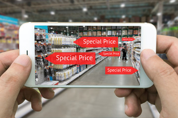 Augmented reality marketing concept. Hand holding smart phone use AR application to check special price in retail store and wholesale market