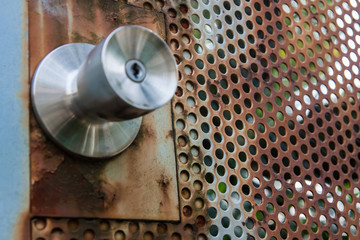 Peeled doorknob of rust and paint