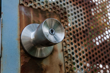 Peeled doorknob of rust and paint