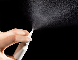 Close-up of nasal drug spraying