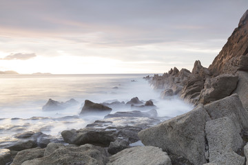 Fototapeta na wymiar Serene seascape in Azkorri beach, Biscay, Basque Country, Spain. Long exposure on a cloudy day.