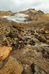 Fototapeta na wymiar Stream from melting of glaciers on the active volcano Mutnovsky.