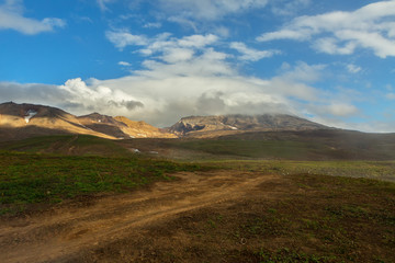 Beautiful scenery slopes of volcano Mutnovsky with clouds.