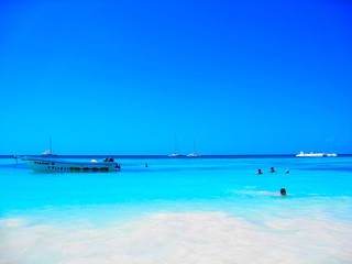 Turquoise turquoise lagoon of a tropical island. Caribbean, beautiful place for recuperation, relaxation, water sports, sunbathing and swimming. Warm sea water, white sand and the wind.