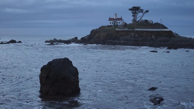 Night falls on a rocky outcropping in Crescent City