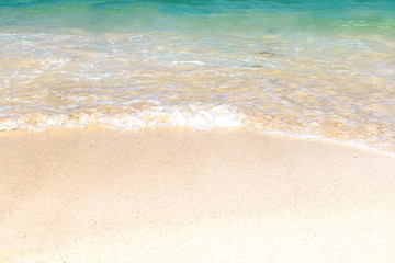Fototapeta na wymiar Wave of blue ocean on sandy beach. Background.