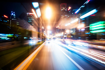 Fototapeta na wymiar blurred traffic light trails on road at night in China.