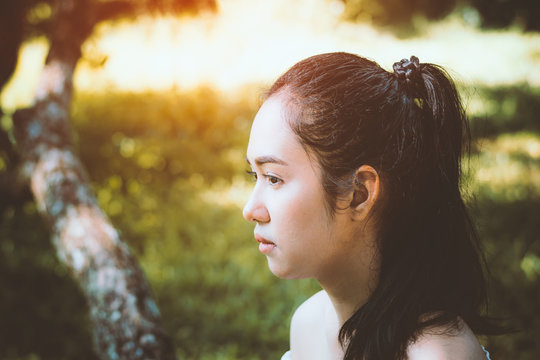  lonely girl in the park,sad girl looking forword and thinking a