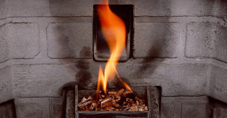 Fire burning in a Pellet stove wood burning fireplace.