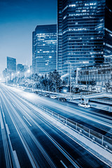 blurred traffic light trails on road at night in China.