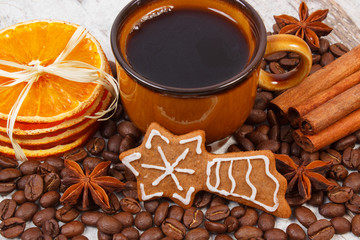 Decorated gingerbread, cup of coffee and grains, spices, christmas time