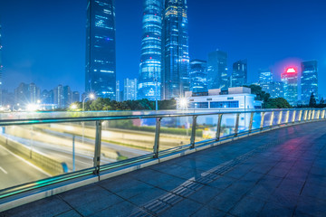 Fototapeta na wymiar footbridge with cityscape at night in Shanghai,China.