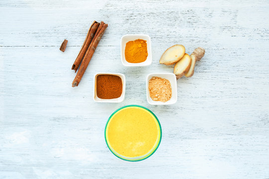 Healthy yellow smoothie of wheat turmeric, cinnamon and ginger, View from above