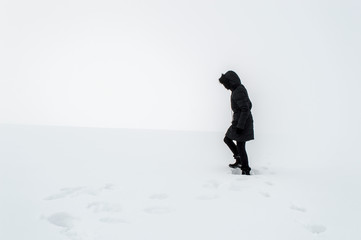 Woman walking in a snowy field