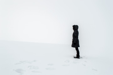 Woman standing in a snowy field