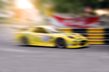 Fototapeta na wymiar Race car racing on speed track with motion blur