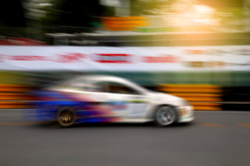 Fototapeta na wymiar Race car racing on speed track with motion blur