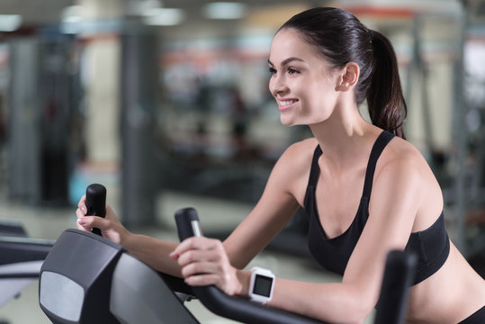 Smiling Woman Running On A Treadmill