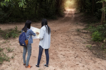 Girl frienship traveling in the woods, Map in hand, and get dire